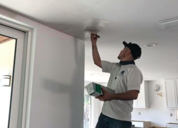 Man painting ceiling